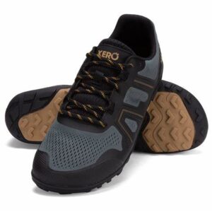 A pair of black and gray athletic shoes with light brown soles is displayed. Ideal for those seeking comfort, one shoe stands upright while the other leans against it, revealing its tread pattern. These shoes, akin to barefoot shoes, feature black laces with yellow accents.