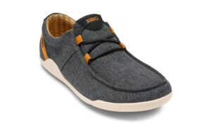 A gray casual shoe with a textured fabric upper, featuring orange accents and black laces, designed for comfort. The white sole offers a barefoot feel, while visible stitching and a small logo on the tongue and heel complement the style—perfect for digital nomads on the go.