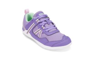 A single purple athletic shoe with pale pink accents and a green interior. Designed for comfort, it features mesh and leather-like materials, a white sole, and purple laces secured with a lace holder. The heel loop ensures easy pull-on for digital nomads on the move.