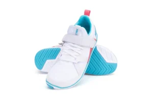 A pair of white athletic sneakers, the Forza Trainer by Xero Shoes, features light blue soles, a blue logo, and pink accents. One shoe stands upright while the other lies on its side, showcasing the tread pattern of this performance footwear.