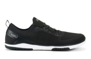 A black Xero Shoes Nexus Knit athletic shoe with a white sole, mesh upper, lace-up design, and "XERO" branding on the side and tongue, showcased in a sleek side profile—perfect for fans of minimalist footwear.