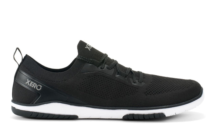 A black Xero Shoes Nexus Knit athletic shoe with a white sole, mesh upper, lace-up design, and "XERO" branding on the side and tongue, showcased in a sleek side profile—perfect for fans of minimalist footwear.