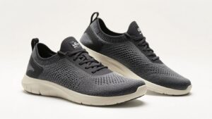 A pair of black and gray Xero Shoes Nexus Knit athletic sneakers with white soles are positioned side by side on a plain white background. The shoes have a knitted mesh upper, lace-up design, and minimalist footwear construction.