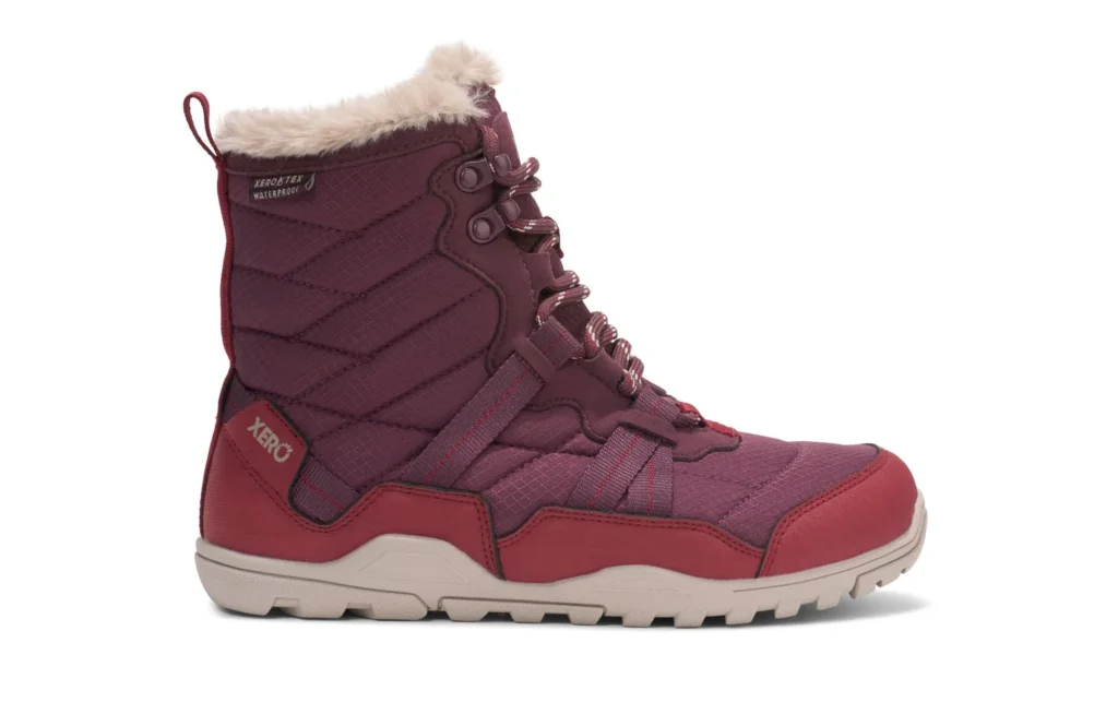 A maroon Xero Winter Boot with quilted fabric, Alpine-inspired faux fur lining at the top, laces, and a beige rubber sole. The side features "XERO" branding near the heel and “WATERPROOF” text near the top.