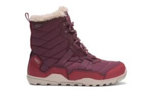 A maroon Xero Winter Boot with quilted fabric, Alpine-inspired faux fur lining at the top, laces, and a beige rubber sole. The side features "XERO" branding near the heel and “WATERPROOF” text near the top.